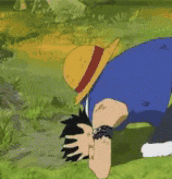 a cartoon character wearing a straw hat is laying on the ground .