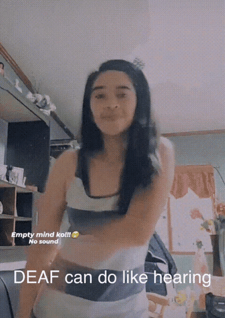 a woman dancing in a room with the words deaf can do like hearing on the bottom