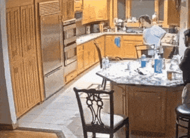 a kitchen with wooden cabinets and stainless steel appliances including a fridge