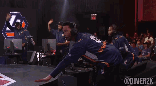 a man wearing headphones and a jersey with the number 23 on it stands on a stage