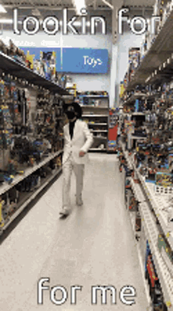a man in a white suit is walking down a aisle of toys