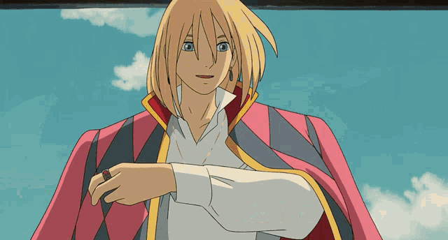 a man with a ring on his finger is wearing a red cape