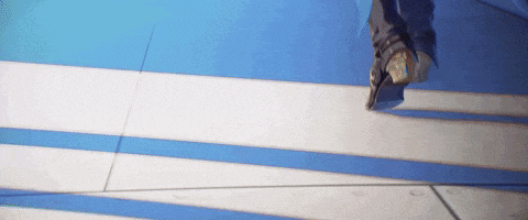a person is rollerblading on a blue and white striped floor
