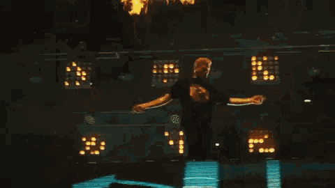 a man is dancing on a stage in front of a bunch of lights