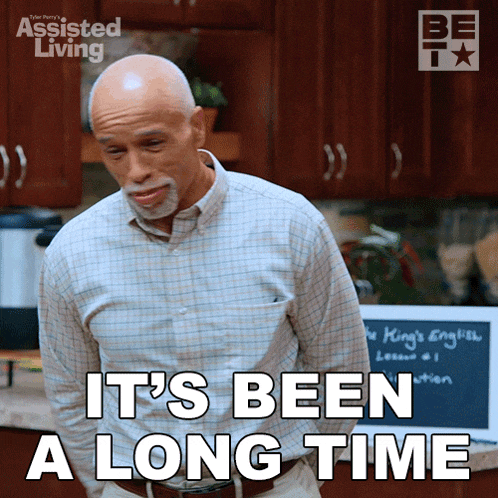 a man says it 's been a long time in front of a chalkboard