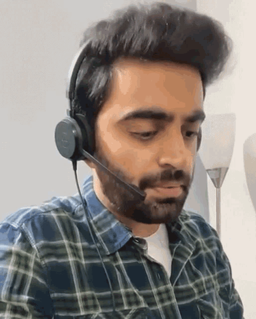 a man with a beard is wearing a headset that says jbl on it