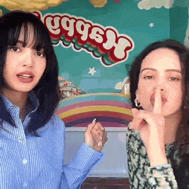 two women standing in front of a sign that says eggs n ' nuggets