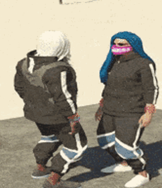 a man and a woman are standing next to each other wearing masks
