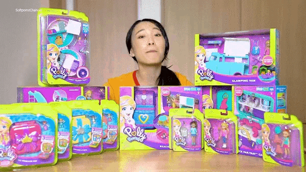 a woman is standing in front of boxes of polly pocket dolls