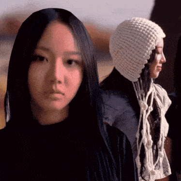 a woman with long black hair and a white hat
