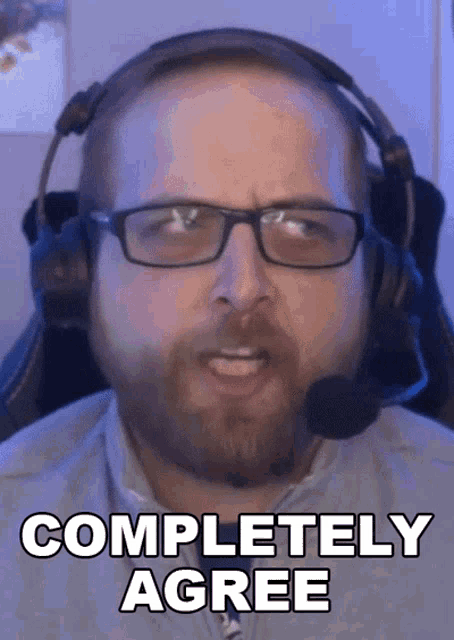 a man wearing glasses and a headset says completely agree