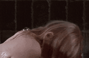 a close up of a woman taking a shower