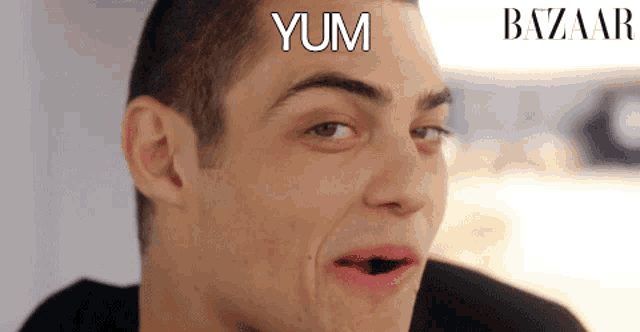 a close up of a man 's face with the words yum written on his forehead