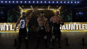 three wrestlers are standing in front of a banner that says the gauntlet