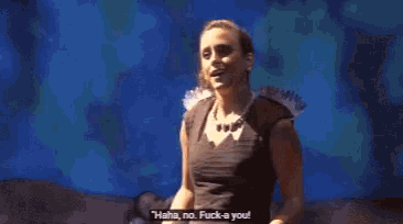 a woman in a black dress with feathers on her shoulders is singing