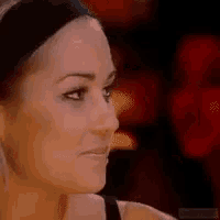 a close up of a woman 's face with a blurred background of another woman .