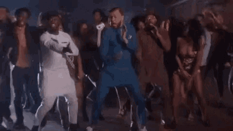 a group of people are dancing in a club .