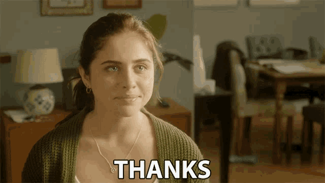 a woman in a green sweater says " thanks "