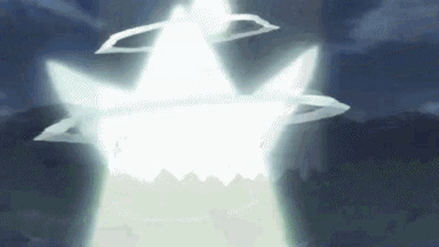 a white star is flying through the air in the dark .