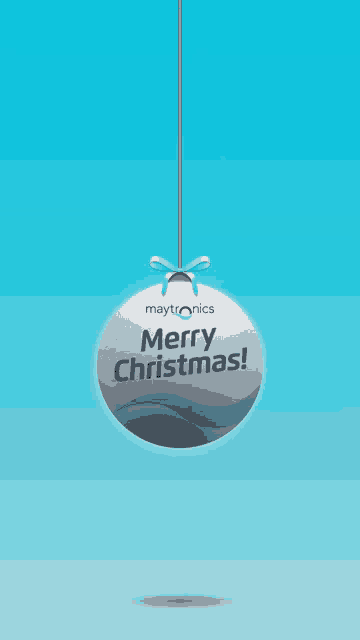 a maytronics merry christmas ornament is hanging from a string