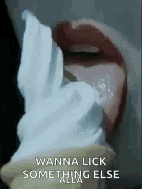 a woman is licking an ice cream cone with her tongue .