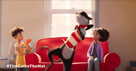 a cat in a hat is playing with two children