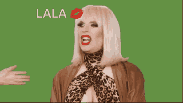 two drag queens are sitting in front of a green background with the word lala on it