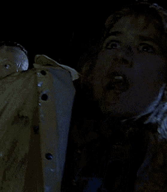 a woman in a yellow jacket with her mouth open