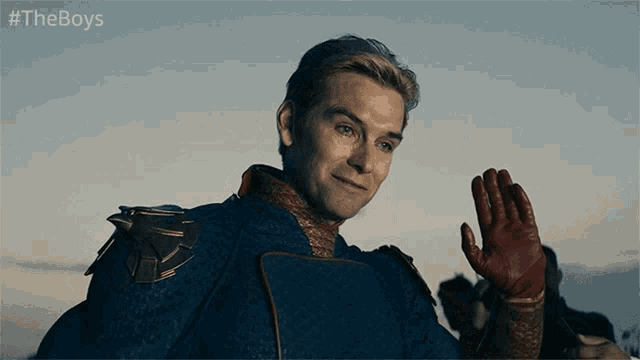 a man in a superhero costume is waving his hand with the hashtag #theboys