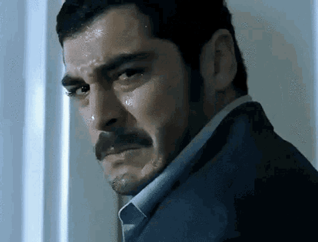 a close up of a man 's face with a tear running down his face