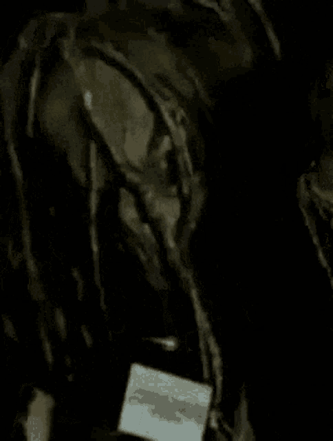 a person with dreadlocks is holding a piece of paper that says ' i love you ' on it