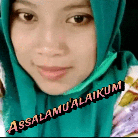 a woman wearing a green hijab with the words assalamu'alaikum written on it