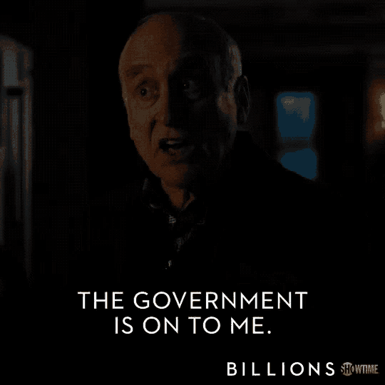 a man in a dark room with the words the government is on to me billions below him