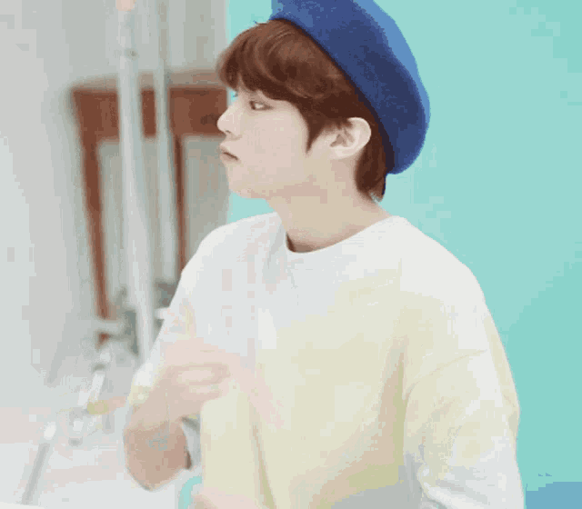 a boy wearing a blue beret and a yellow shirt