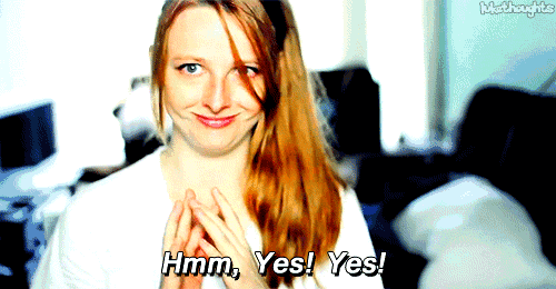 a woman says hmm yes yes in front of a couch