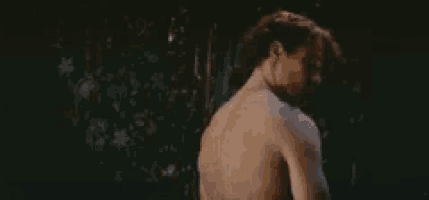 a man and a woman are standing next to each other in a dark room .
