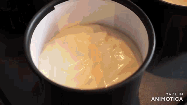 a close up of a bowl of yogurt with the words made in animatica below it