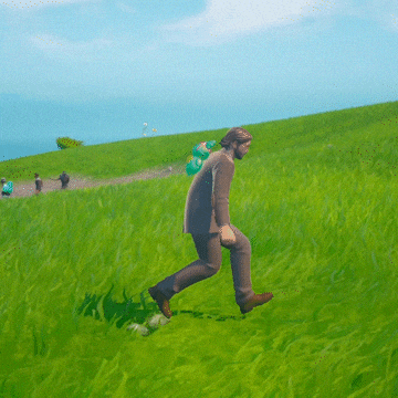 a man in a suit stands in a grassy field
