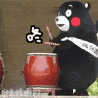 a teddy bear is playing a drum in front of a red drum .
