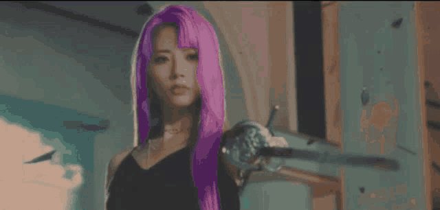 a woman with pink hair is holding a sword in her hand