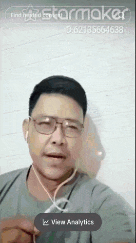 a man wearing glasses and ear buds is shown on a screen that says starmaker
