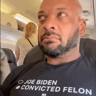a man with a beard is wearing a shirt that says joe biden convicted felon .