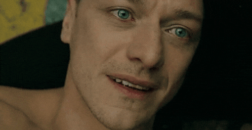 a close up of a man 's face with a beard