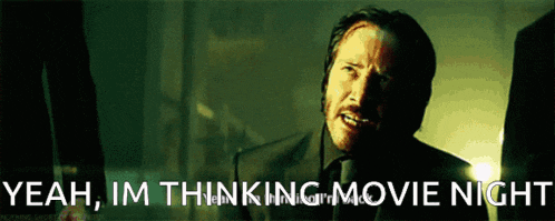 a man in a suit and tie is saying yeah , im thinking movie night