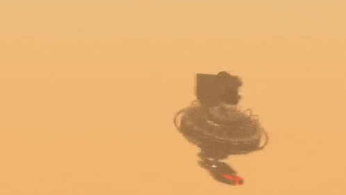 a computer generated image of a robot flying through the air in the desert .