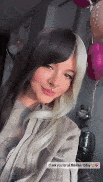 a woman with a nose ring is taking a selfie with balloons in the background and says thank you for all the love today