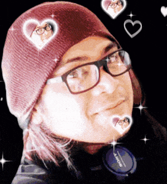 a person wearing glasses and a beanie has a sony headphone on their neck