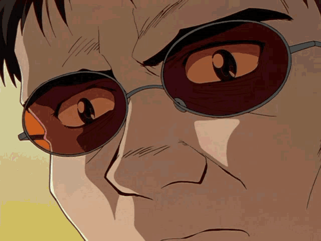 a close up of a man 's face wearing sunglasses