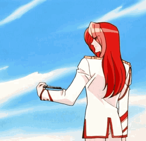 a woman with long red hair is standing in front of a blue sky .
