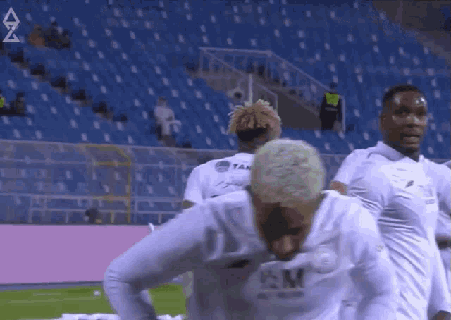 a group of soccer players wearing white jerseys with km on the front